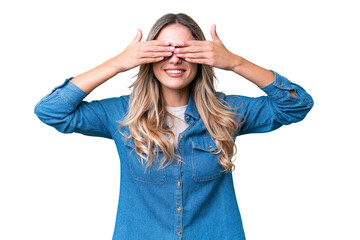 Young Uruguayan woman over isolated background covering eyes by hands and smiling