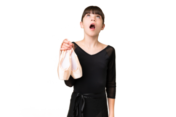 Little caucasian girl practicing ballet over isolated background looking up and with surprised expression