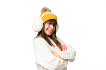 Little caucasian girl wearing winter muffs over isolated background with arms crossed and looking forward