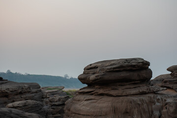 Rocky cliff, part of mountain rocks isolated on evening nature background.