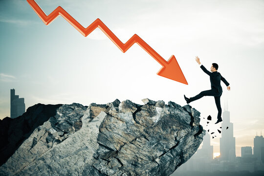 Businessman falling off a cliff with a red downward arrow symbolizing financial crisis.