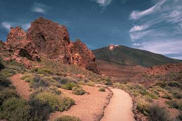 Erosion of massive volcanic rock with path of gr131 to the peak of Pico del Teide on the background...