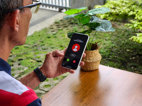 Bokeh. Illustration of a man receiving a spam call from a cellphone with a blurry background (The user interface design used is self-made, created using vector editing software).
