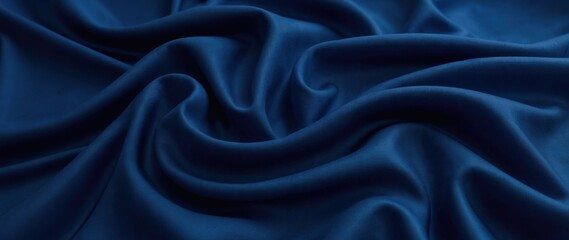 Fototapeta premium Luxurious dark blue silk fabric with smooth flowing folds, soft waves, glossy highlights, and deep shadows, elegant shiny texture, rich satin material, abstract textile background.