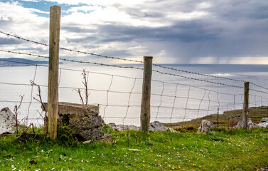 Fence next to the coastal single track road between Meenacross and Crohy Head south of Dungloe, County Donegal - Ireland
