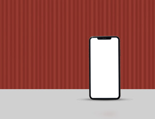 A smartphone with a blank white screen standing against a red corrugated background.