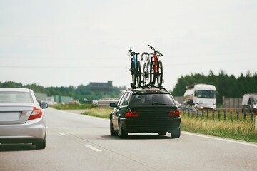 Cars driving on a road with bikes on the roof