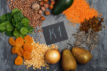 An example of a range of products containing vitamin K1. The concept of proper balanced nutrition. Products with the inscription vitamin K1 on a dark background, top view.