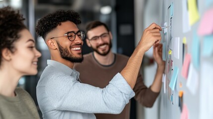 Brainstorming in Progress: A diverse team of young professionals collaborate on a project, using sticky notes on a whiteboard to brainstorm ideas.