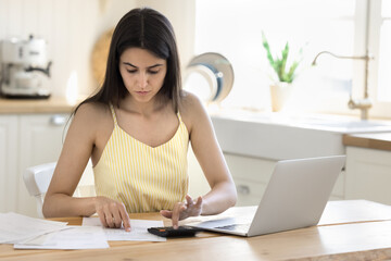 Financial paperwork. Busy young woman manage domestic finances at home office calculate expenses...