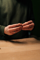 Obraz premium Vertical close-up cropped shot of technician preparation to replacement smartwatch battery, showing precision workmanship during delicate electronic maintenance process. Concept of repairing, upgrade.