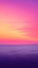 Vibrant pink, purple, yellow and orange sunset illuminating clouds from above