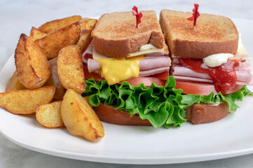 ham  sandwich  with lettuce , tomato and cheese