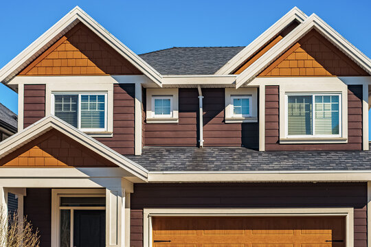 Facade of a house with nice windows. Real Estate Exterior Front House in a residential neighborhood.