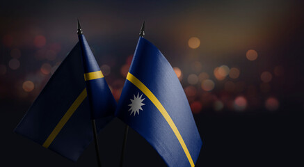 Small flags of the Nauru on an abstract blurry background