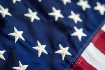 Fototapeta premium Close-up image of the American flag featuring white stars on a blue background