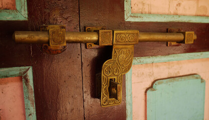 Brass decorated door latch in a Nepalese house in the Himalayas