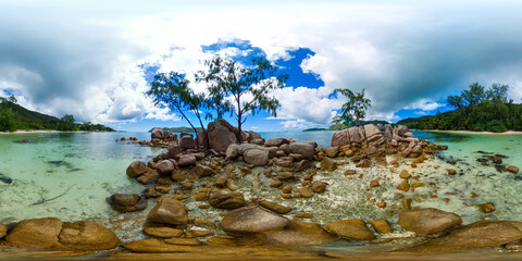 A rocky island with crystal-clear water and lush trees. Praslin, Seychelles. Smoon Island. 360 Degree view.