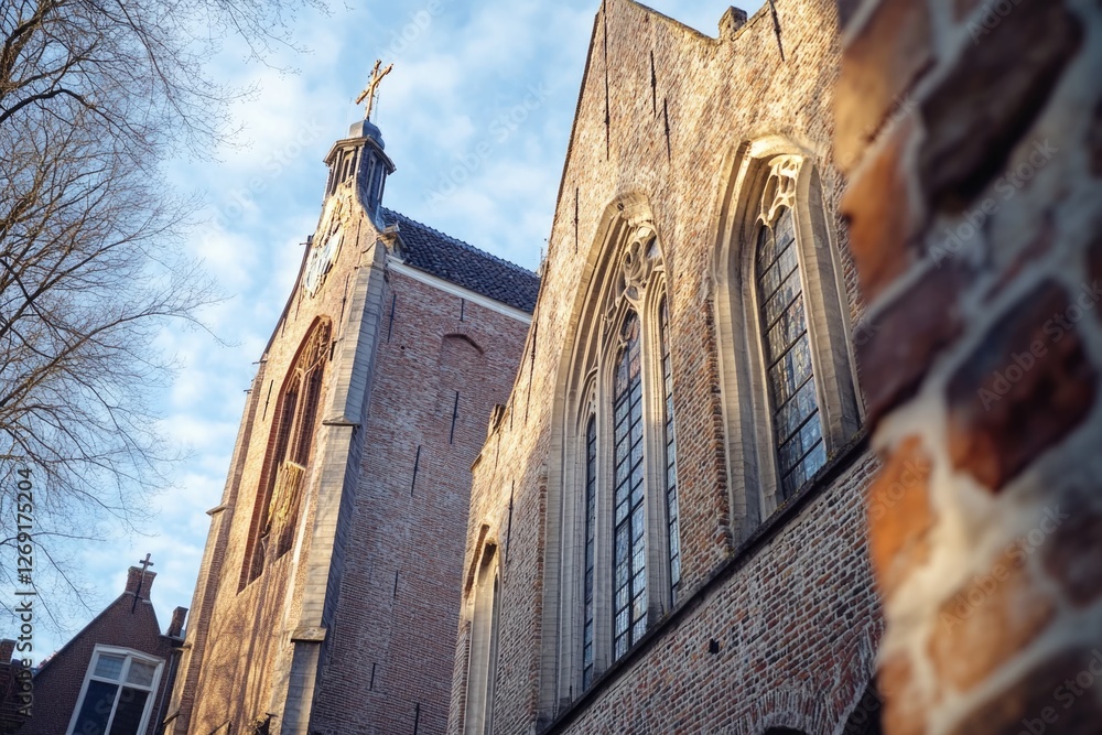 Poster a tall brick building with a clock tower, perfect for architecture or cityscape scenes