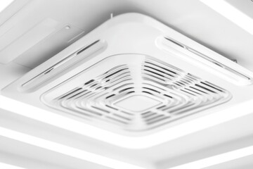 A modern bathroom exhaust fan installed on the ceiling