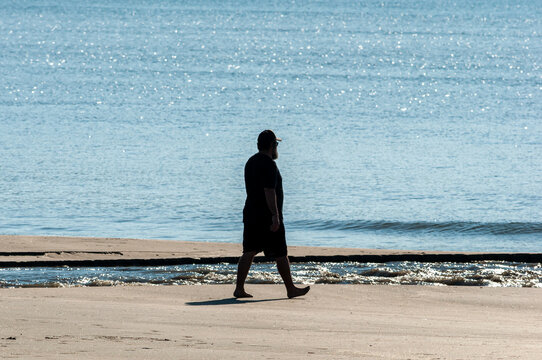 silhouette man walking on the beach