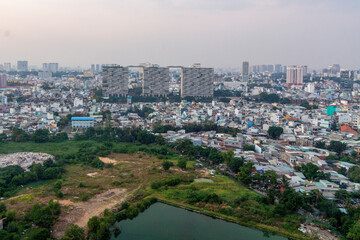 Fototapeta premium Saigon, Vietnam - 30 Jun, 2022 - An aerial view of Saigon shows high-rise buildings and apartments.