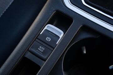 Close-up of car parking brake and auto hold button