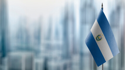 Small flags of the Salvador on an abstract blurry background