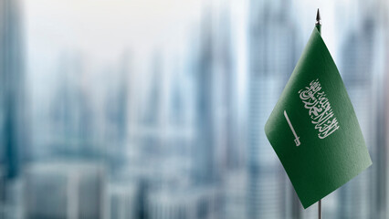 Small flags of the Saudi Arabia on an abstract blurry background