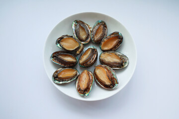Abalone on a plate on white background