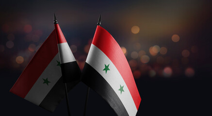 Small flags of the Syria on an abstract blurry background