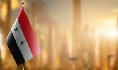 Small flags of the Syria on an abstract blurry background