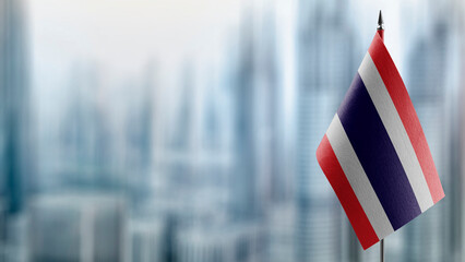 Small flags of the Thailand on an abstract blurry background