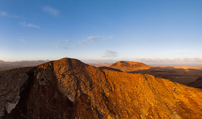 Mid aspect aerial distance panoramic image of Volcan Calderon Hondo volcano and volcanic crater near Corralejo and Lajares, Fuerteventura, Canary Islands, Spain