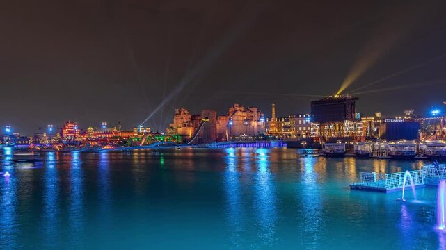 Panorama showing Riyadh Boulevard World entertainment park with illuminated attractions famous landmarks. Largest artificial lake on the world with floating boats night timelapse. Riyadh. Saudi Arabia