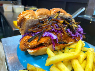 Challah Sandwiches. Sabich challah with chicken schnitzel, Eggplant, Eggs, Hummus, and Tahini. Israeli Street Food. Tel Aviv Market