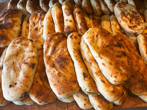Nan-e Barbar. Fresh tradition iraqian bread sold at local farmers market. Panuozzo Italian sandwich of pizza bread