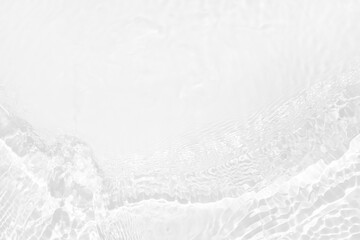 Obraz premium White water with ripples on the surface. Defocus blurred transparent white colored clear calm water surface texture with splashes and bubbles. Water waves with shining pattern texture background.