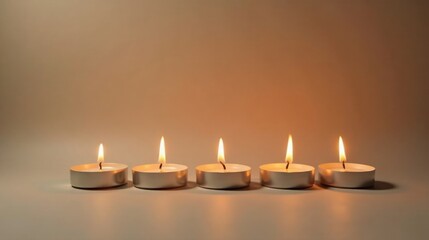 Serene Illumination Five Small Candles Burning Brightly in a Row Against a Soft Background