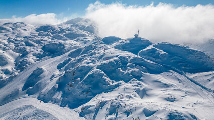 Aerial view of Vogel Ski Resort in Slovenia during winter with blanket of snow covers the slopes...