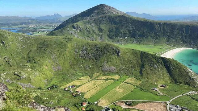 Panoramic view from the top of Mannen over the mountains and coastline of Haukland Beach in the Lofoten Islands, Norway