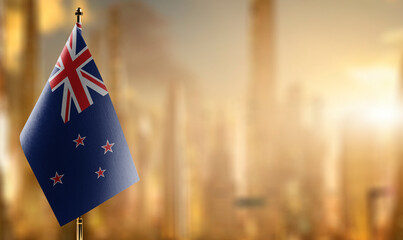 Small flags of the New Zealand on an abstract blurry background