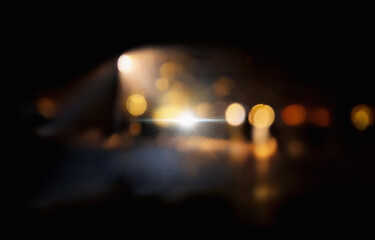 A bright white light with radial rays against a black background.