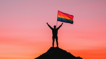 Transgender Day of Visibility concept. Triumphant Silhouette Atop Mountain Peak at Vibrant Sunset