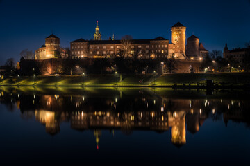 Poland, Krakow: Royal Castle of Wawel by night with reflection in Vistula River
