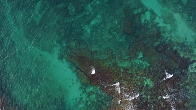 Top down view clear water of Mediterranean sea in Puglia, southern Italy. Aerial view sea with rocky coast
