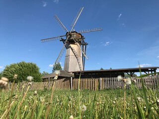 A mill in a field grinds grain on