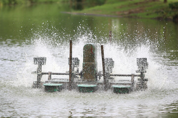 Water Aeration System:  A powerful water aerator churning up the surface of a pond, creating a cascade of bubbles and enhancing water quality. © Khemmanat