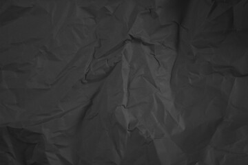 Black Wrinkled Fabric: A close-up shot of crumpled black fabric, highlighting the deep shadows and...