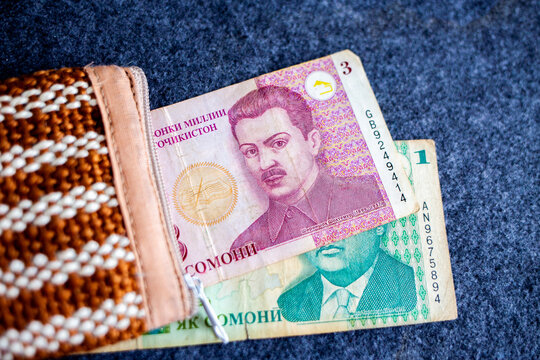 Tajikistani somoni banknotes partially in a wallet
